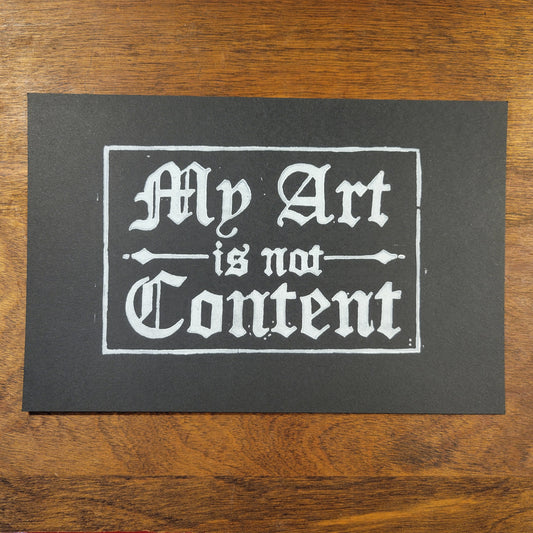 Not Content linocut print white on black, cropped